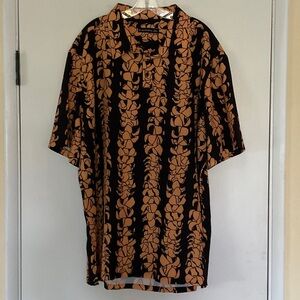 Manaola “Puakenikeni” Black and Orange Botanical Polo